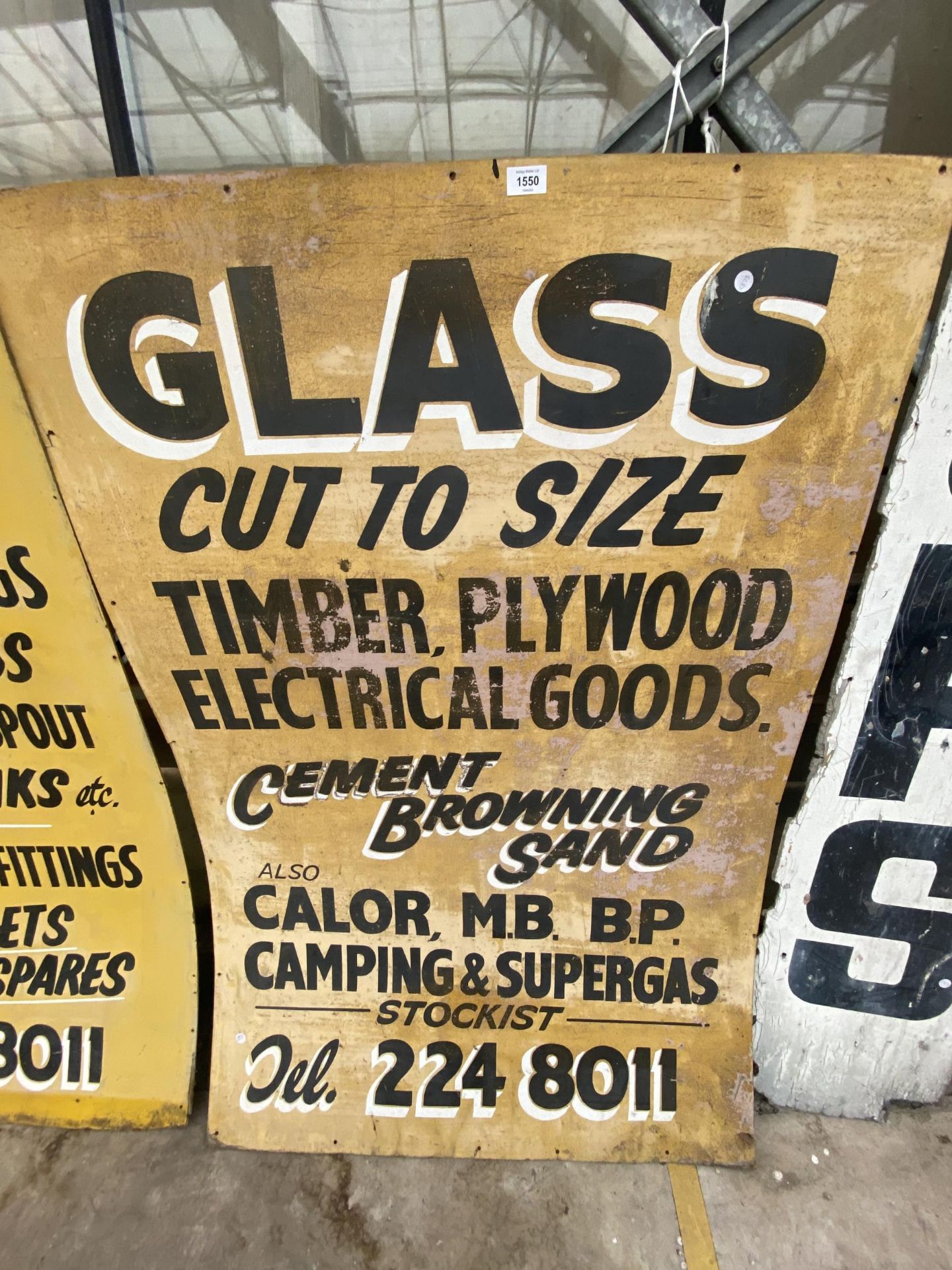 A WOODEN 'GLASS CUT TO SIZE' SIGN