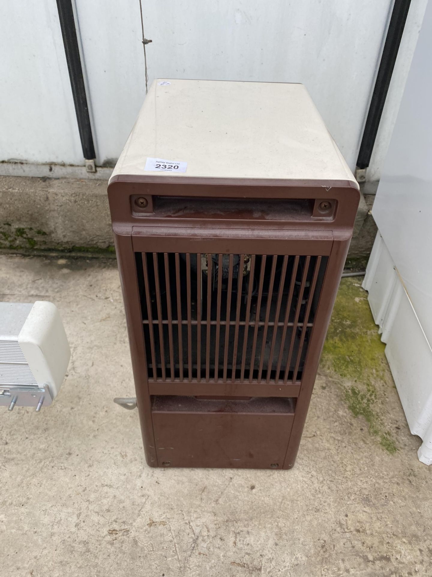 A SMALL CREAM AND BROWN DEHUMIDIFIER