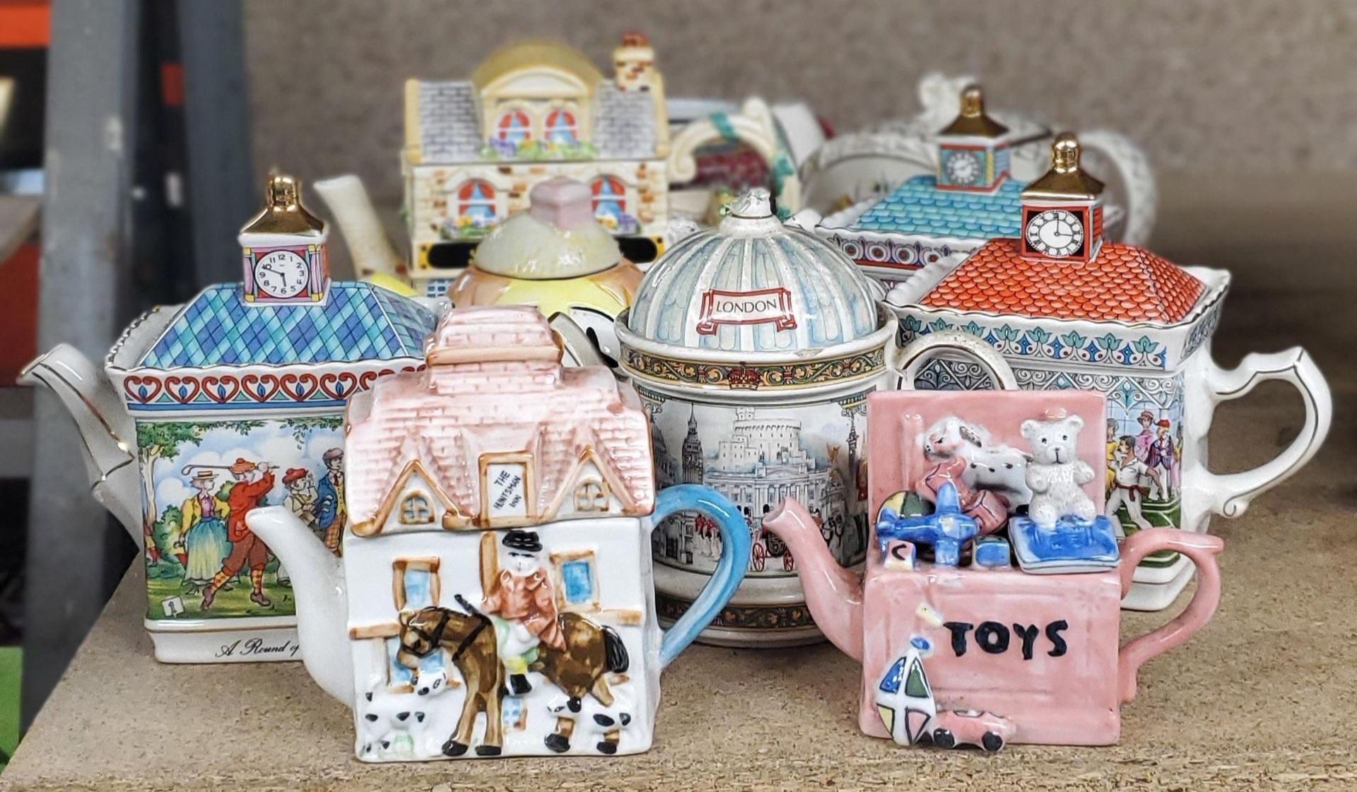 A COLLECTION OF NOVELTY CERAMIC TEAPOTS ETC