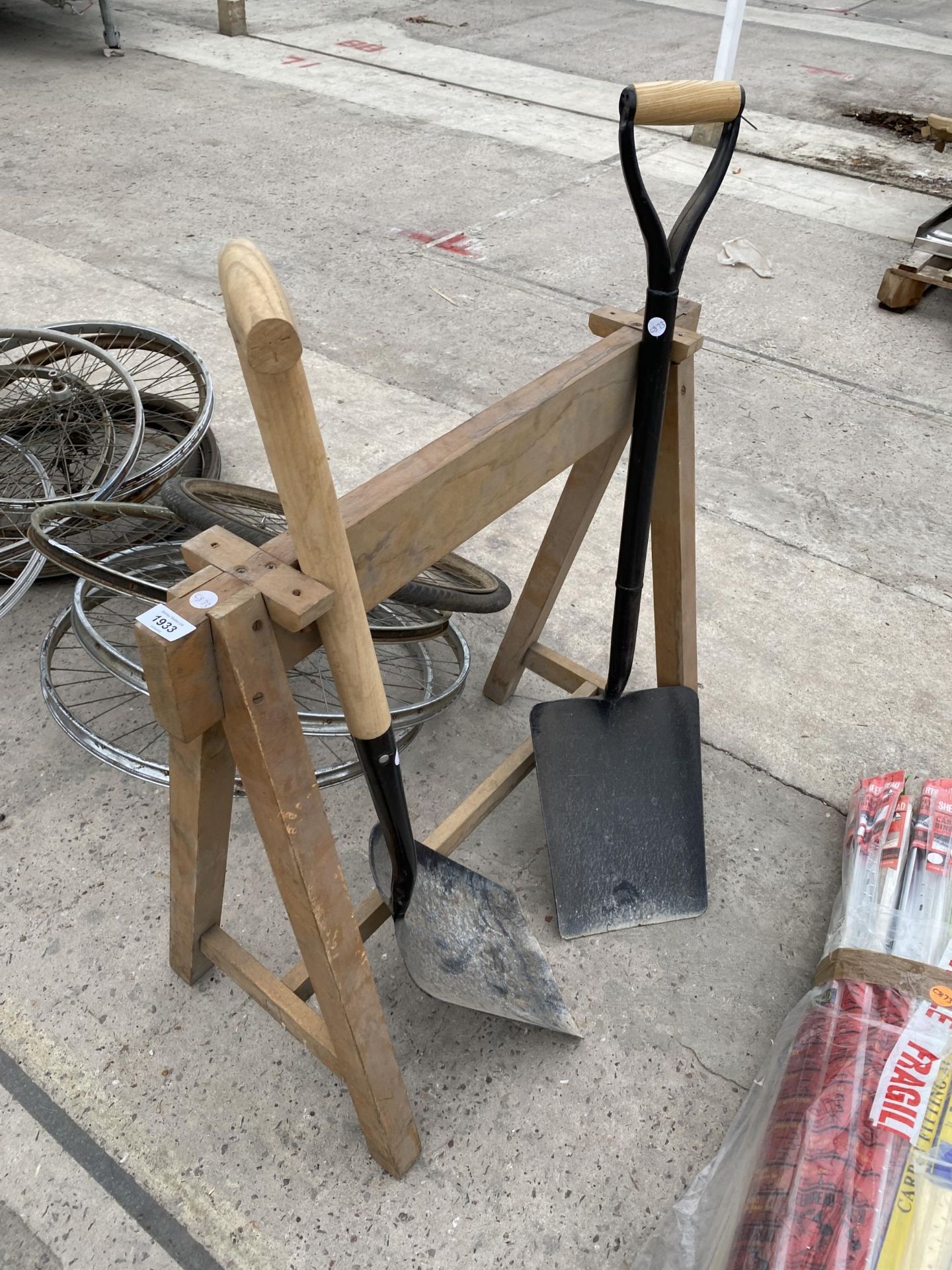 A WOODEN BUILDERS TRESTLE AND TWO SHOVELS