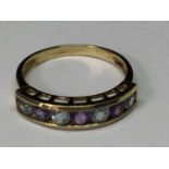 A 9 CARAT GOLD RING WITH FOUR AQUAMARINES AND THREE AMETHYSTS IN A LINE SIZE M/N