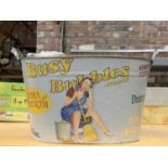 A GALVANISED WASHING TUB WITH 'BUSY BUBBLES DETERGENT' ADVERTISEMENT