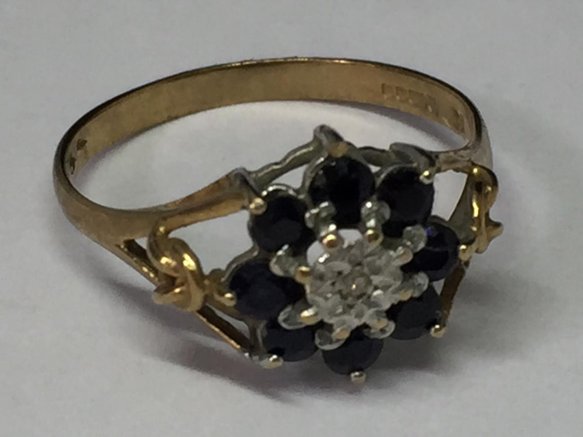 A 9 CARAT GOLD RING WITH DIAMONDS AND SAPPHIRES SIZE N/O