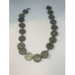 A NECKLACE MADE UP OF NINETEEN SILVER THREE PENCES