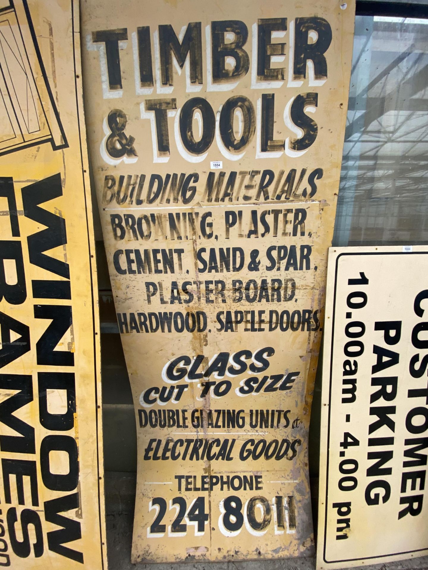 A WOODEN 'TIMBER & TOOLS' SIGN