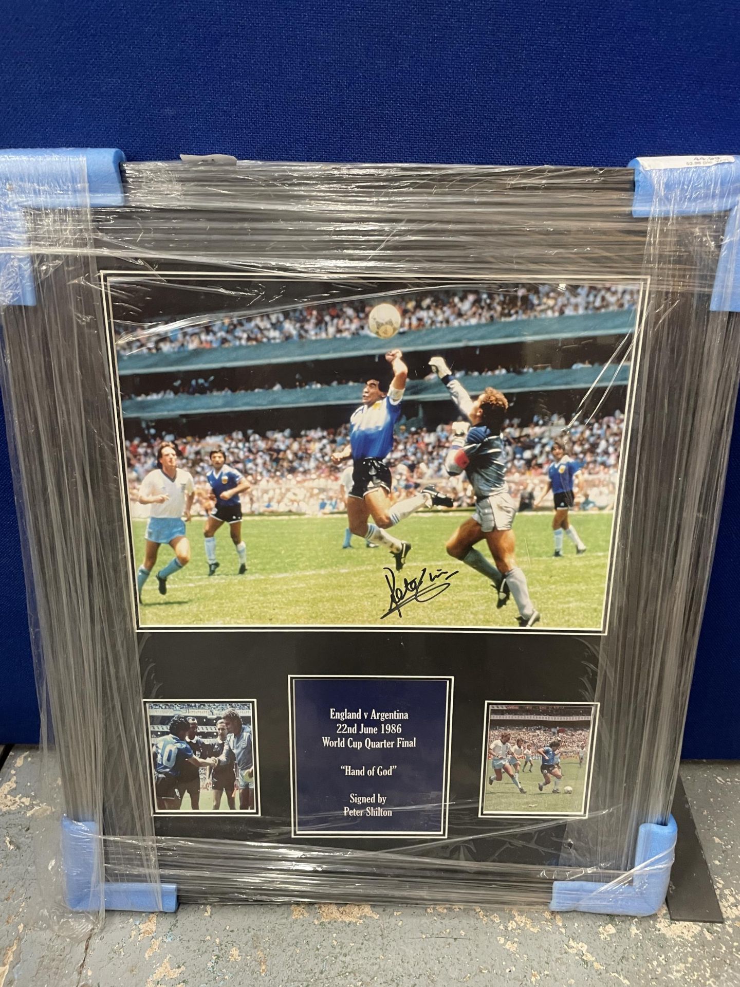 A FRAMED 1986 WORLD CUP 'HAND OF GOD' PHOTO SIGNED BY PETER SHILTON, WITH ALL STAR SIGNINGS