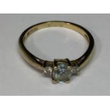 A 9 CARAT GOLD RING WITH A CENTRE AQUAMARINE WITH A DIAMOND EACH SIDE SIDE SIZE K