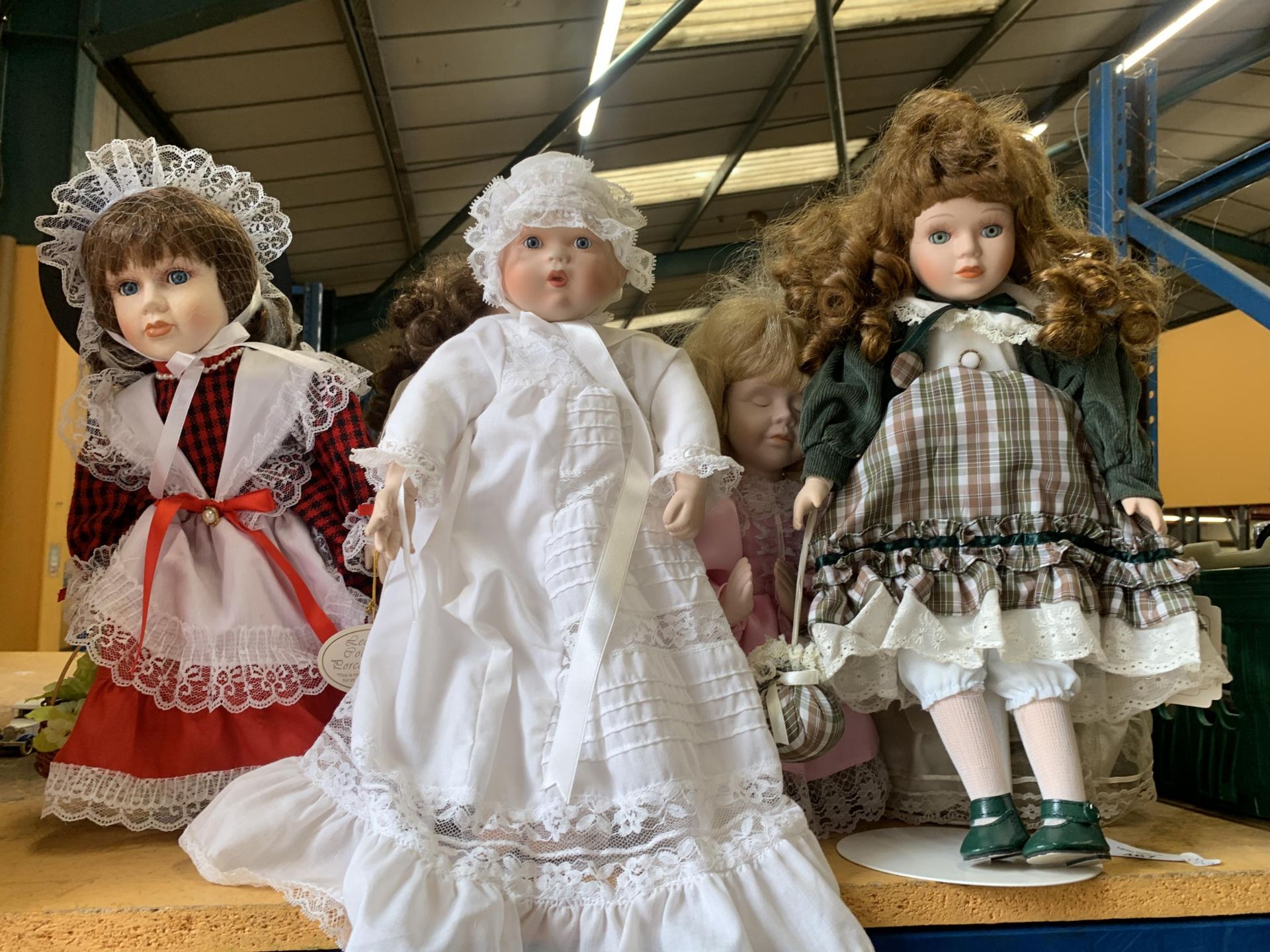 A GROUP OF DOLL MODELS ON STANDS WITH A BOXED EXAMPLE