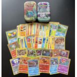 TWO TINS OF ASSORTED POKEMON CARDS, HOLOS ETC