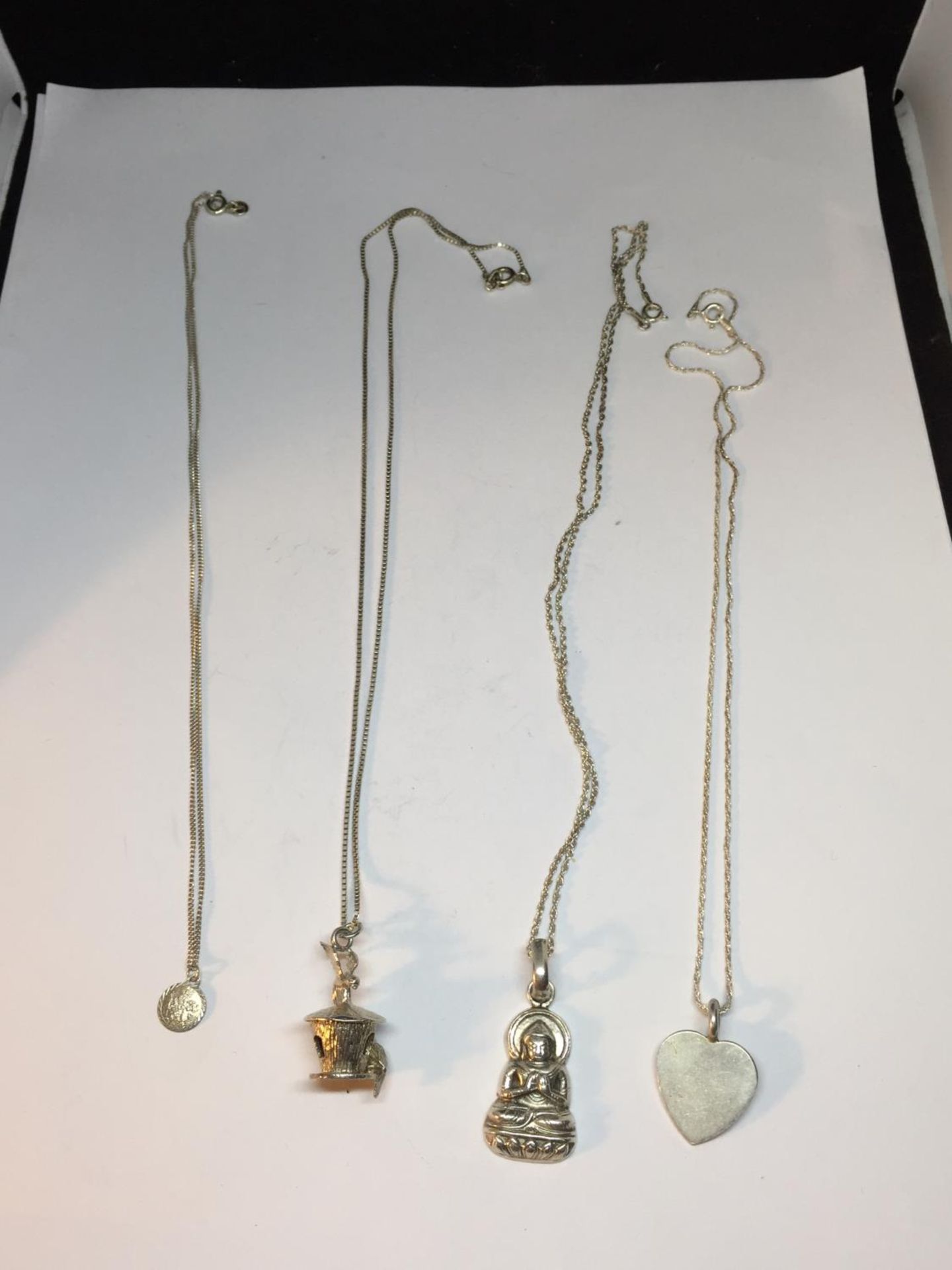 FOUR SILVER NECKLACES WITH PENDANTS