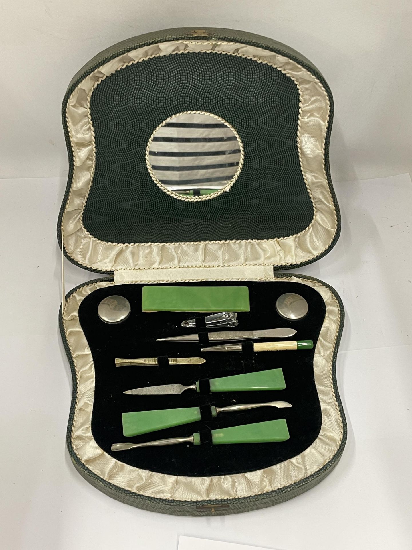 AN ART DECO CASED MANICURE SET WITH JADE STYLE HANDLES