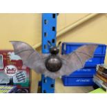 A METAL MODEL OF A FLYING BAT