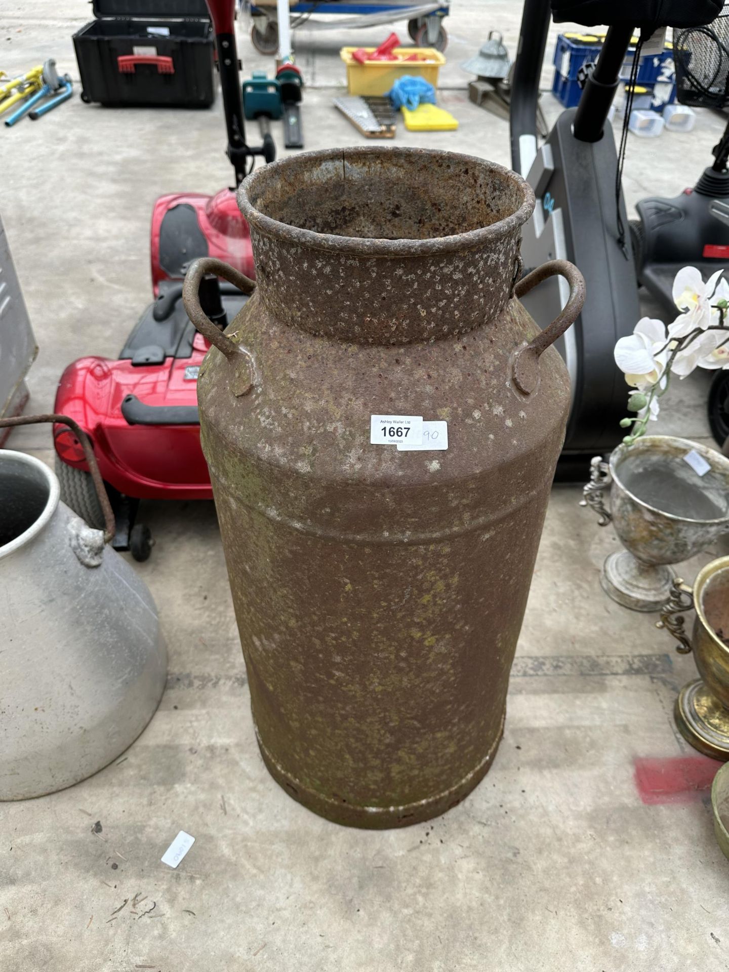 A VINTAGE CAST IRON MILK CHURN