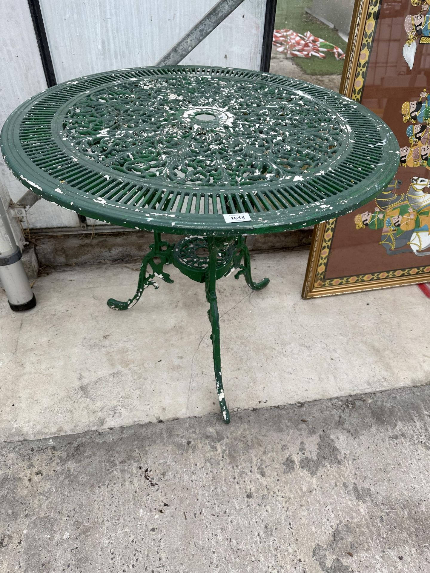 A ROUND CAST ALLOY BISTRO TABLE