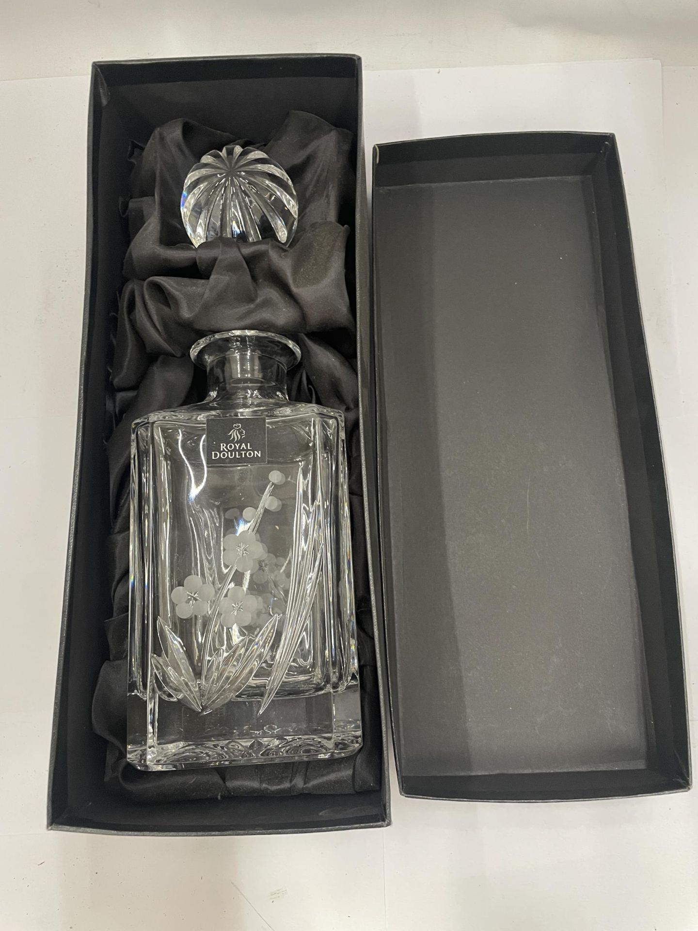 A BOXED ROYAL DOULTON GLASS DECANTER WITH ETCHED FLORAL DESIGN