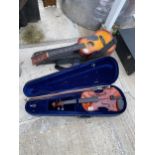 A CASED VIOLIN AND A CHILDS ACOUSTIC GUITAR