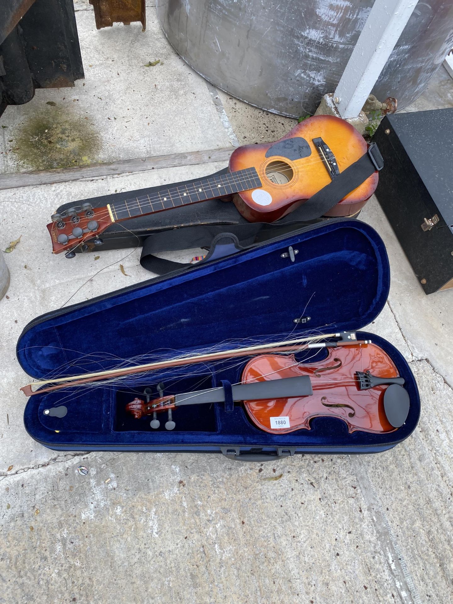 A CASED VIOLIN AND A CHILDS ACOUSTIC GUITAR