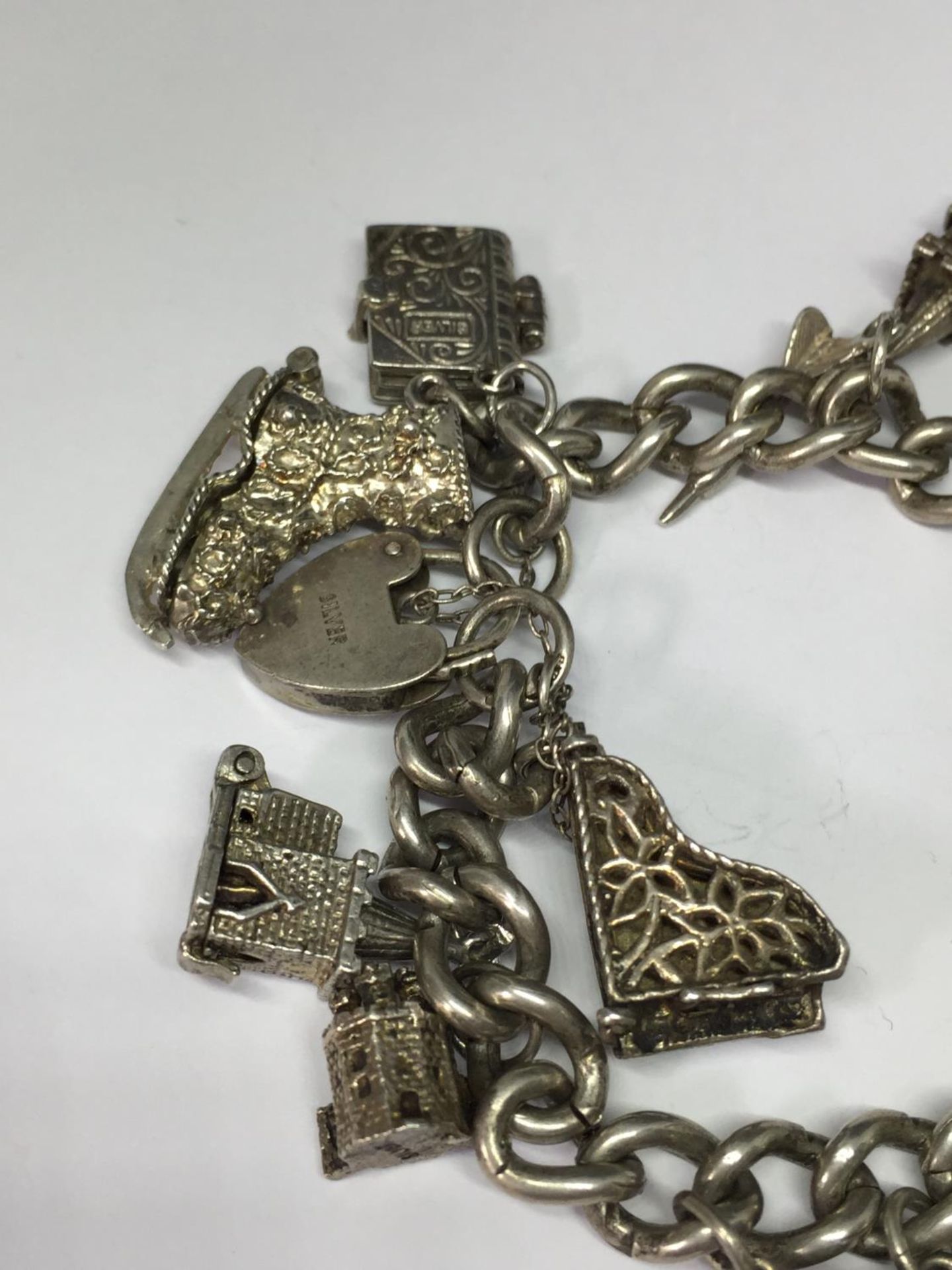 A SILVER CHARM BRACELET WITH THIRTEEN VARIOUS CHARMS - Image 3 of 4