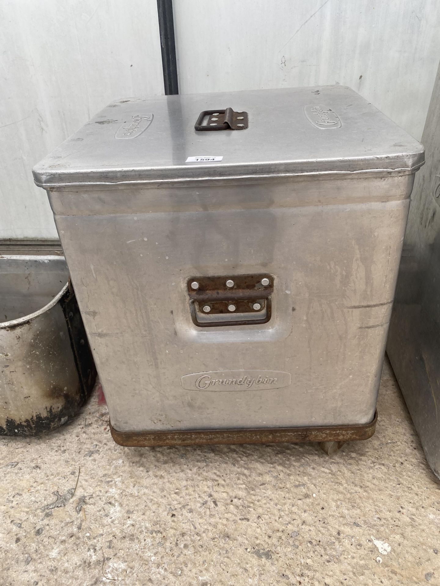 A STAINLESS STEEL GRUNDYBIN WITH LID AND WHEELED BASE (50CM x 42CM x 42CM)