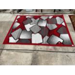 A MODERN RED AND GREY PATTERNED RUG