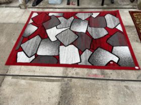 A MODERN RED AND GREY PATTERNED RUG