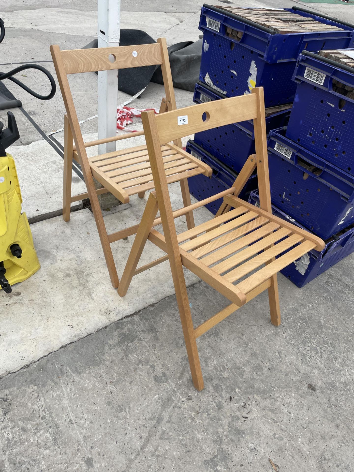 A PAIR OF FOLDING WOODEN CHAIRS