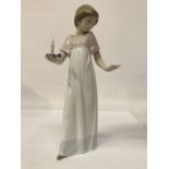 A NAO FIGURE OF A GIRL HOLDING A CANDLE