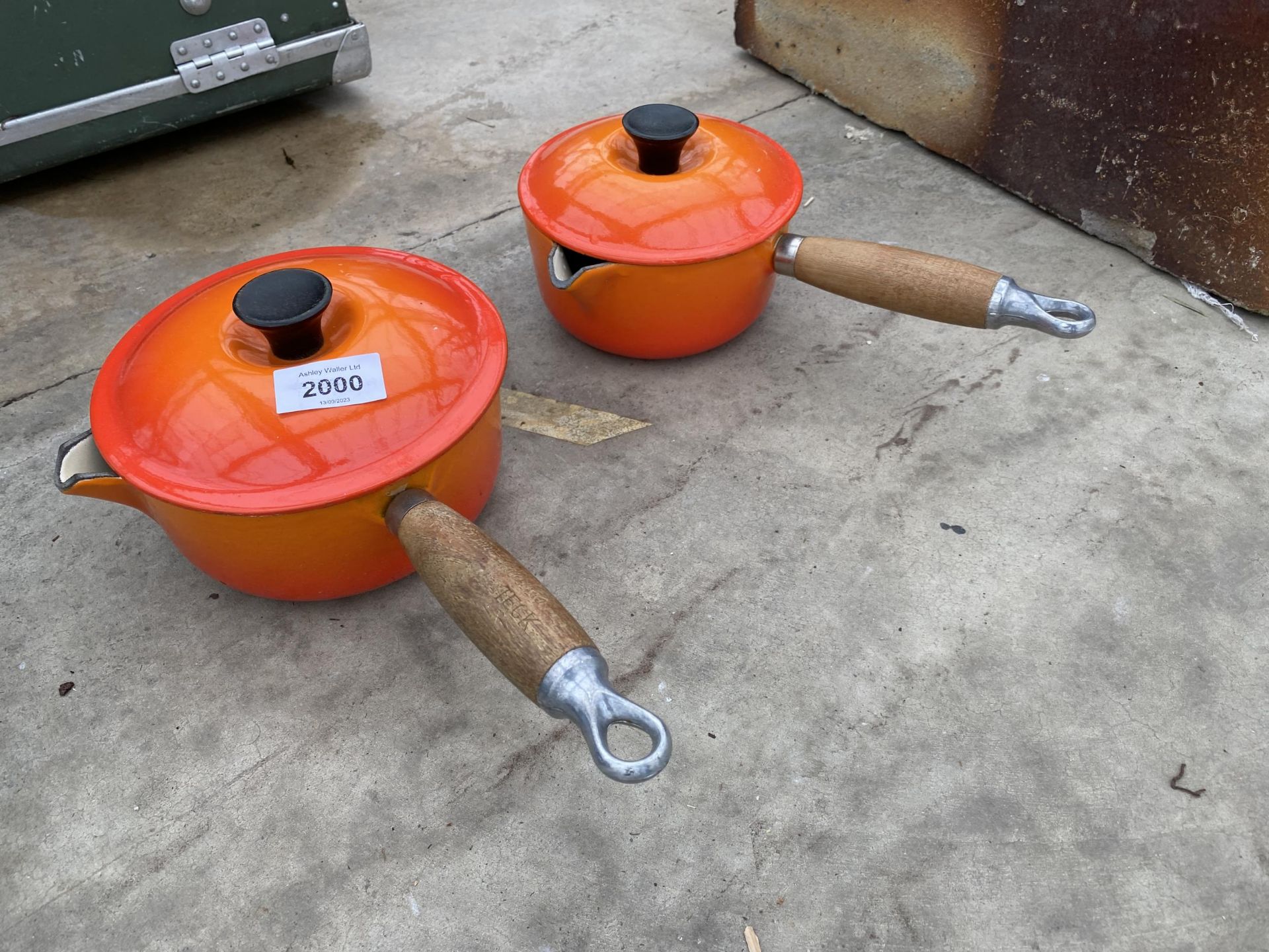 TWO ORANGE LE CREUSET PANS WITH WOODEN HANDLES AND LIDS