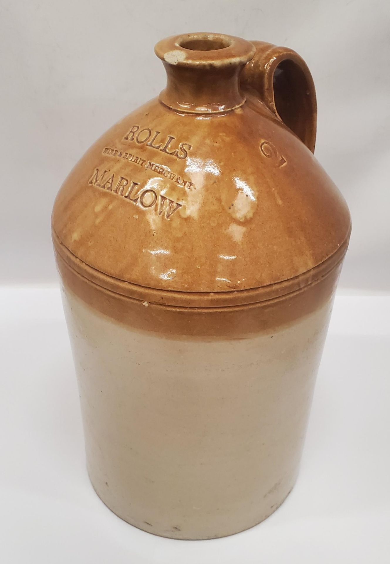 A DOULTON AND CO STONEWARE FLAGON STAMPED 'ROLLS WINE AND SPIRIT MERCHANT, MARLOW, HEIGHT APPROX
