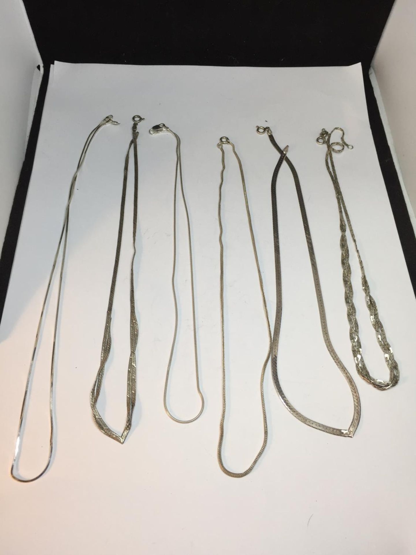 SIX SILVER NECKLACES