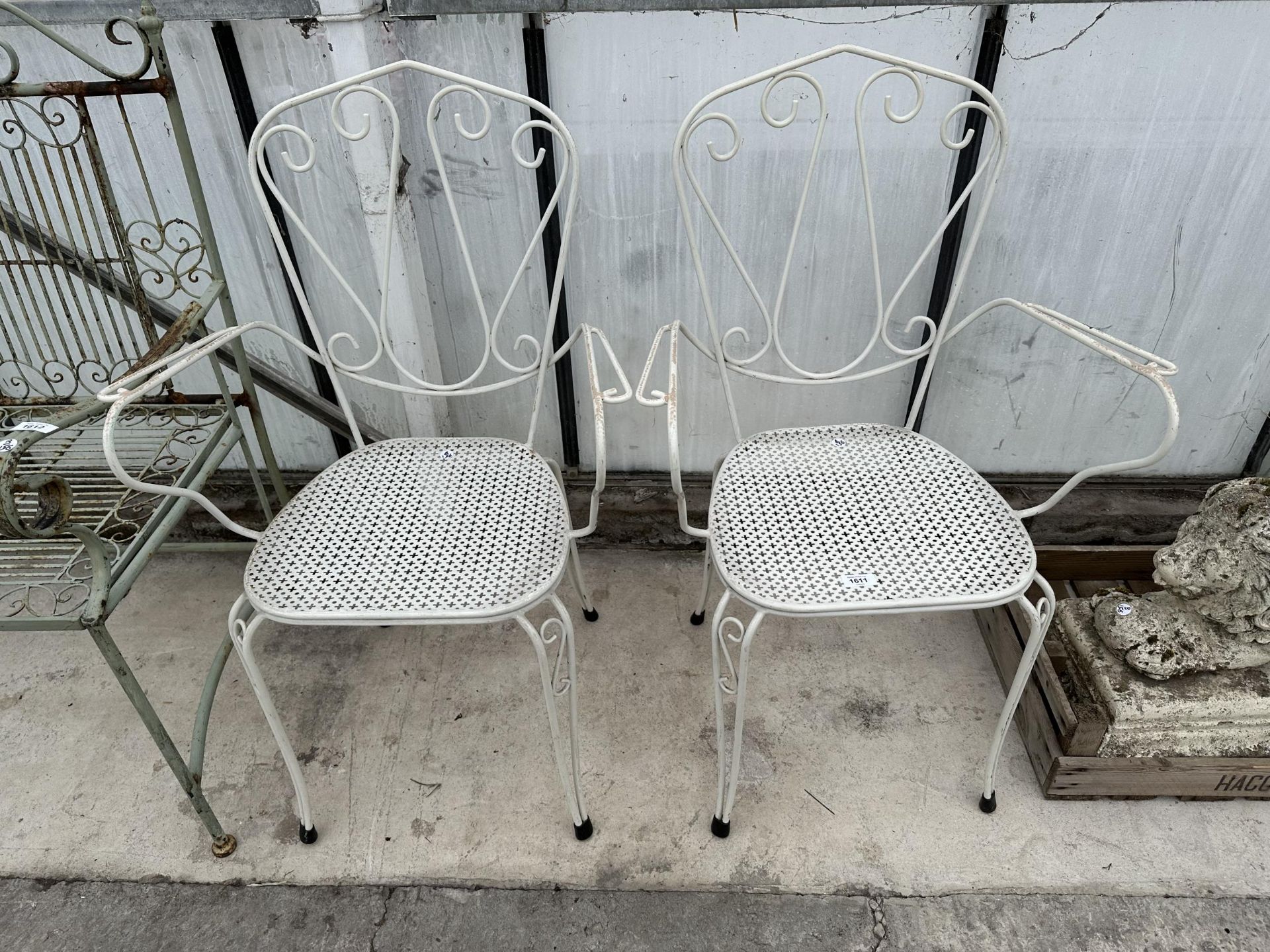 A PAIR OF DECORATIVE TURNED METAL BISTRO CHAIRS