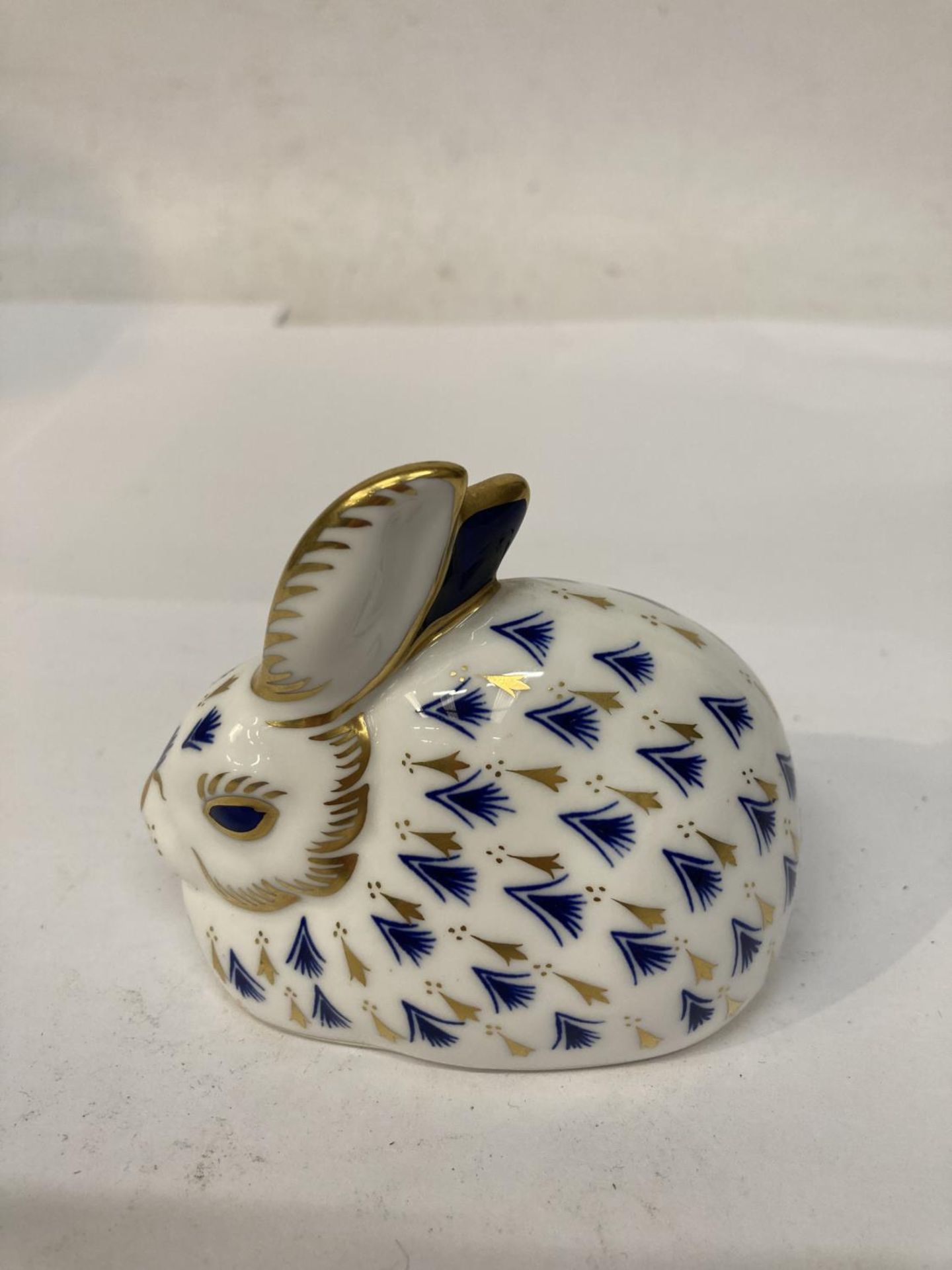 A ROYAL CROWN DERBY RABBIT PAPERWEIGHT, GOLD STOPPER
