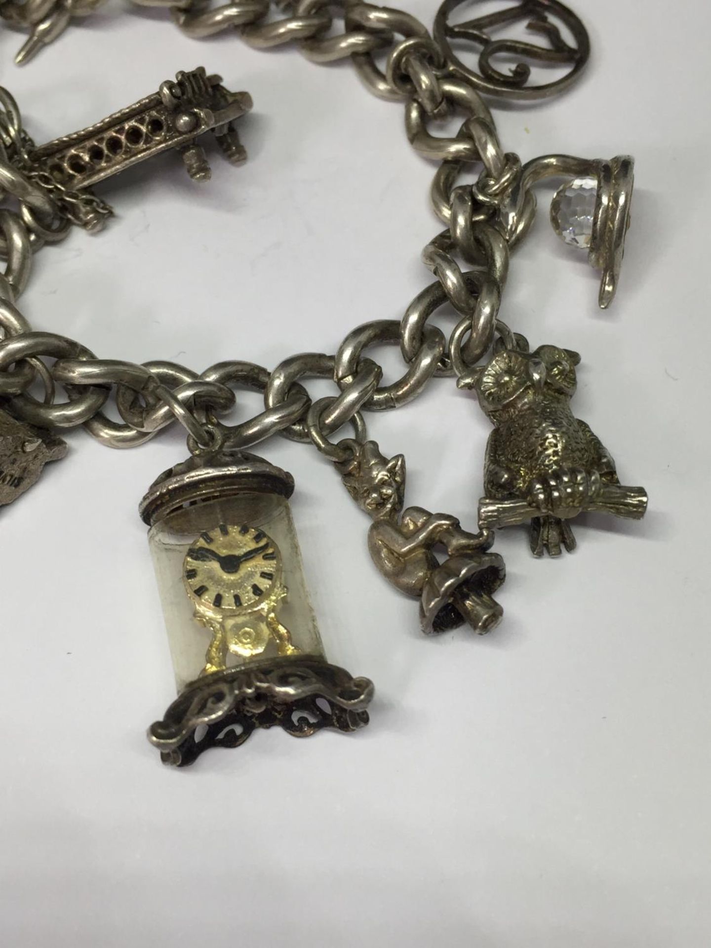 A SILVER CHARM BRACELET WITH THIRTEEN VARIOUS CHARMS - Image 2 of 4