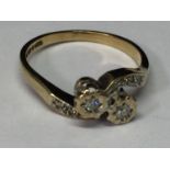 A 9 CARAT GOLD RING WITH DIAMONDS ON A TWIST DESIGN SIZE M