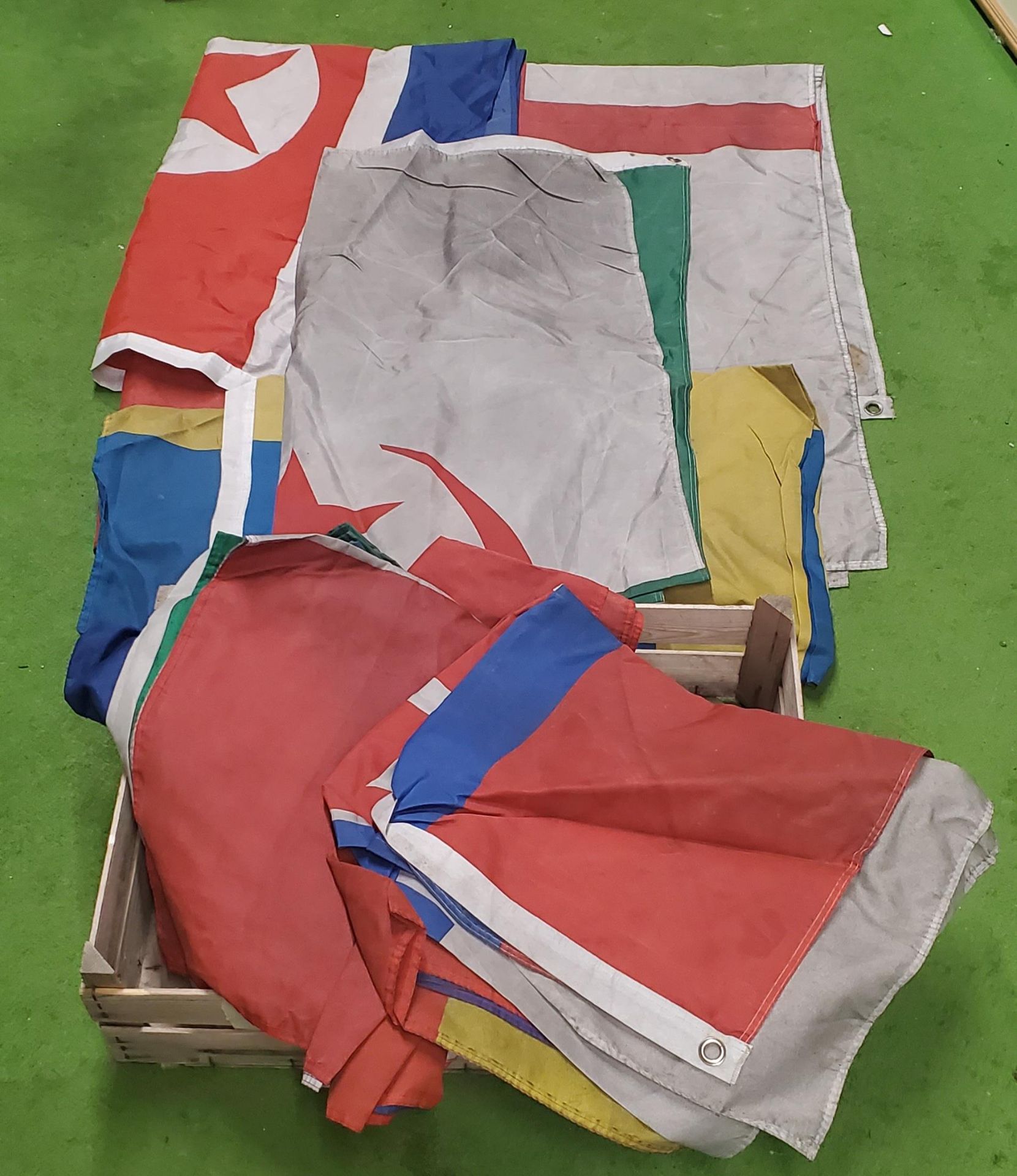 A WOODEN BOX OF ASSORTED WORLD FLAGS APPROX 19