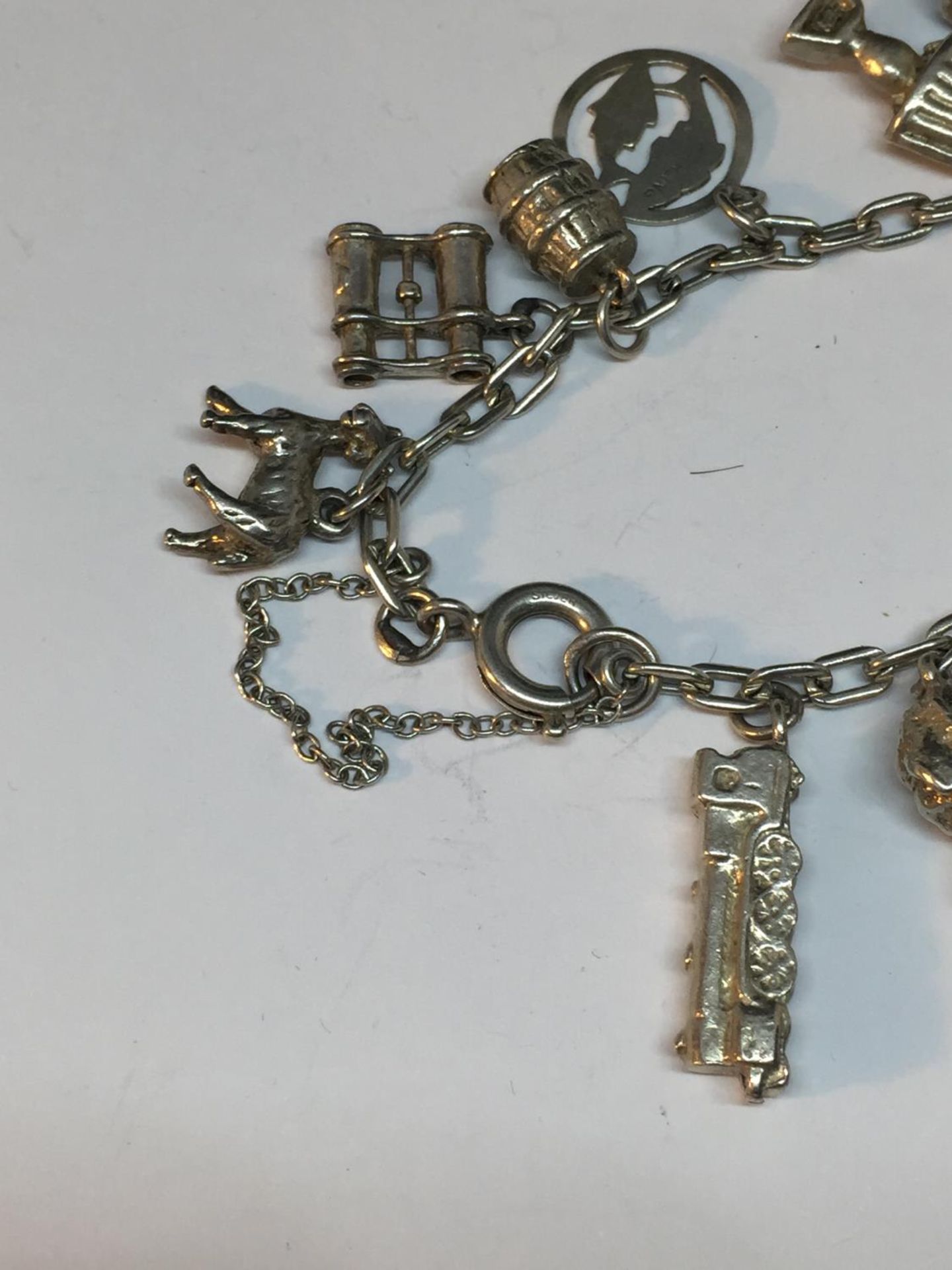 A SILVER CHARM BRACELET WITH FOURTEEN CHARMS - Image 4 of 4