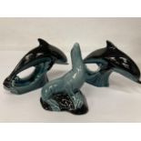 TWO POOLE POTTERY DOLPHIN FIGURES TOGETHER WITH A SEAL
