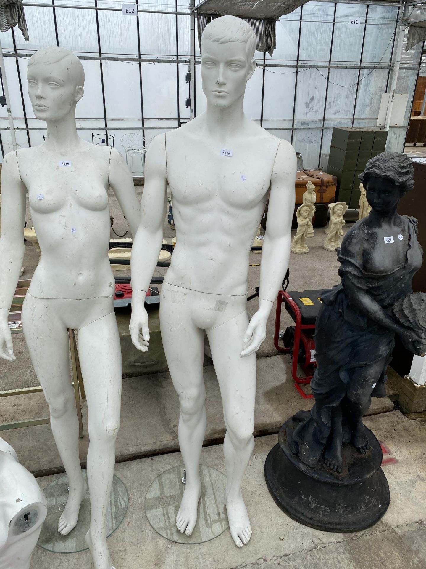A MALE LIFE SIZE MANNEQUIN ON A STAND