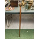 A WALKING STICK WITH A BRASS FOUR FACED BUDDAH HANDLE