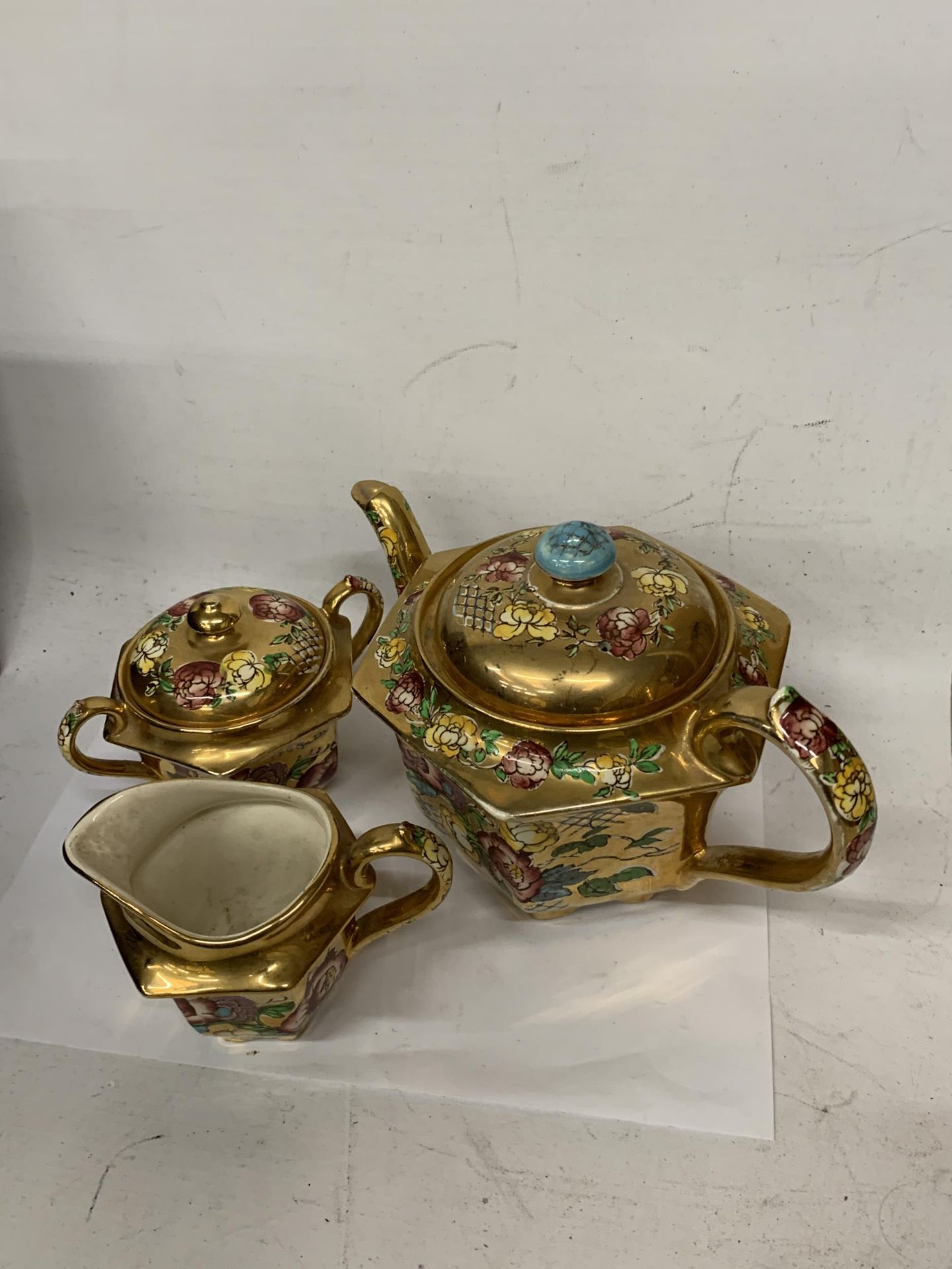 A SADLER GILT AND FLORAL TEAPOT, LIDDED SUGAR BOWL AND MILK JUG SET a/f