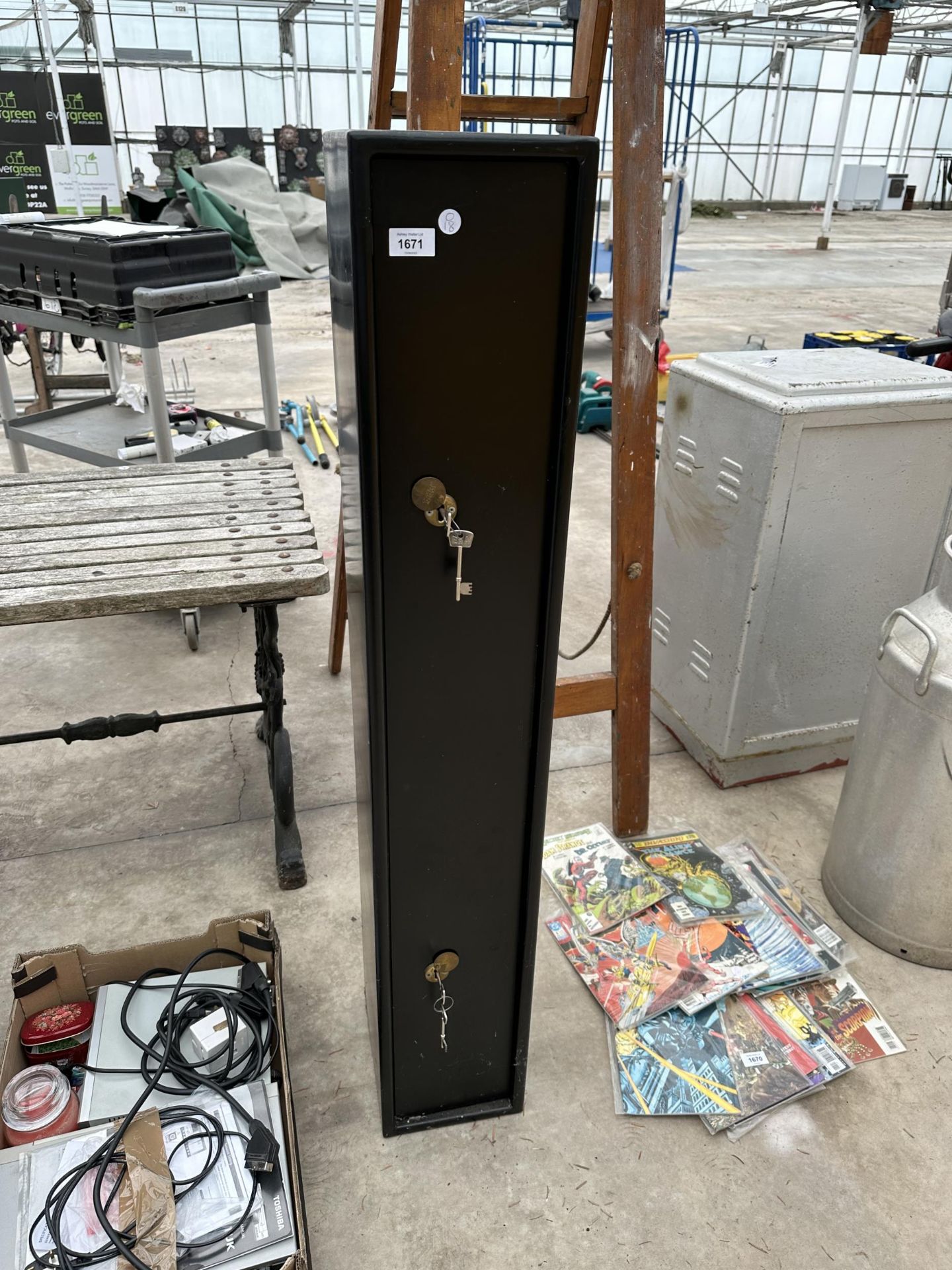 A METAL GUN CABINET WITH TWO SETS OF KEYS