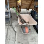 A METAL WHEEL BARROW AND TOOLS TO INCLUDE A SLEDGE HAMMER AND A PICK AXE ETC