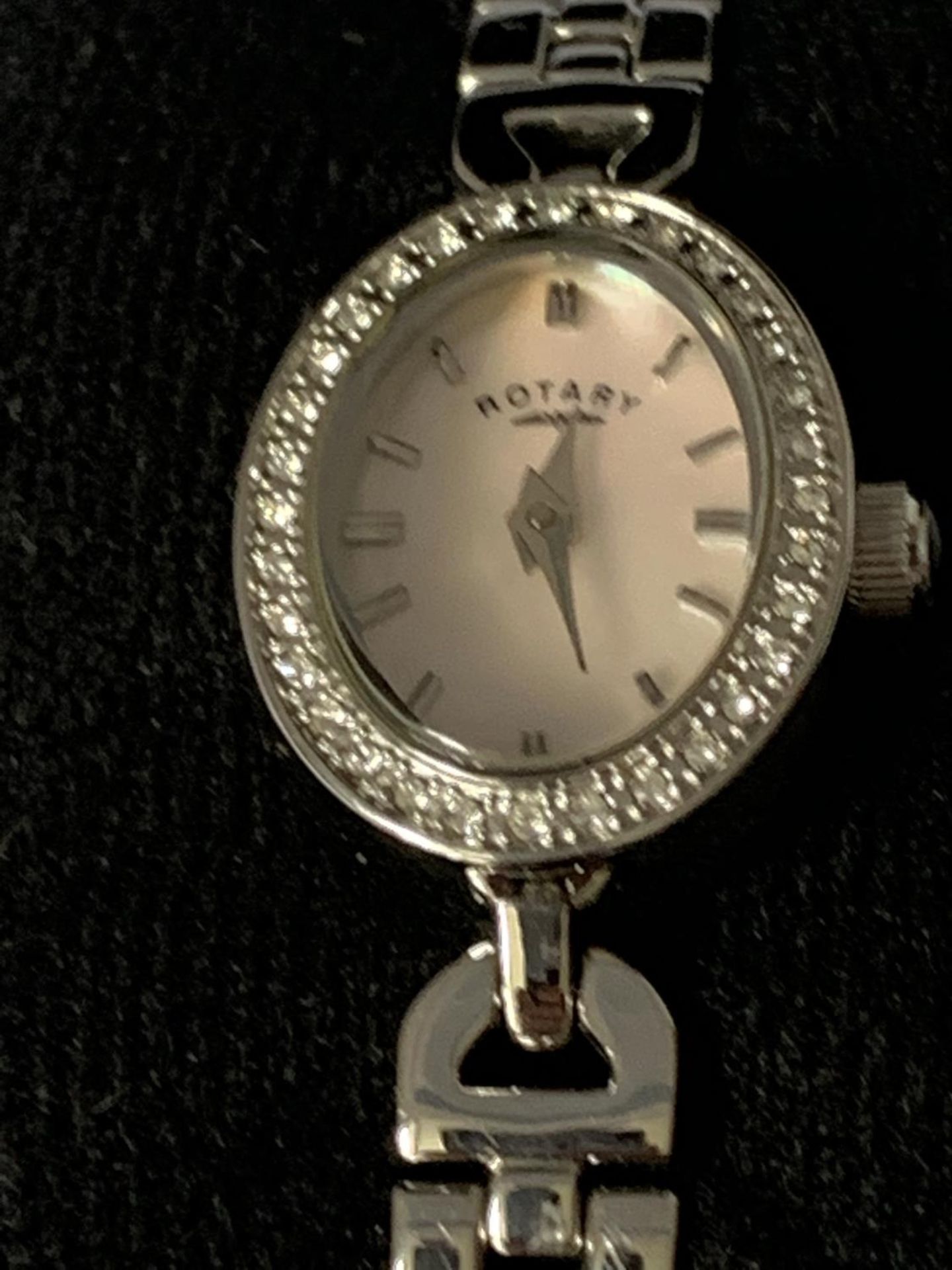 A ROTARY WRIST WATCH WITH PINK MOTHER OF PEARL OVAL FACE SURROUNDED BY CLEAR STONES - Image 2 of 3