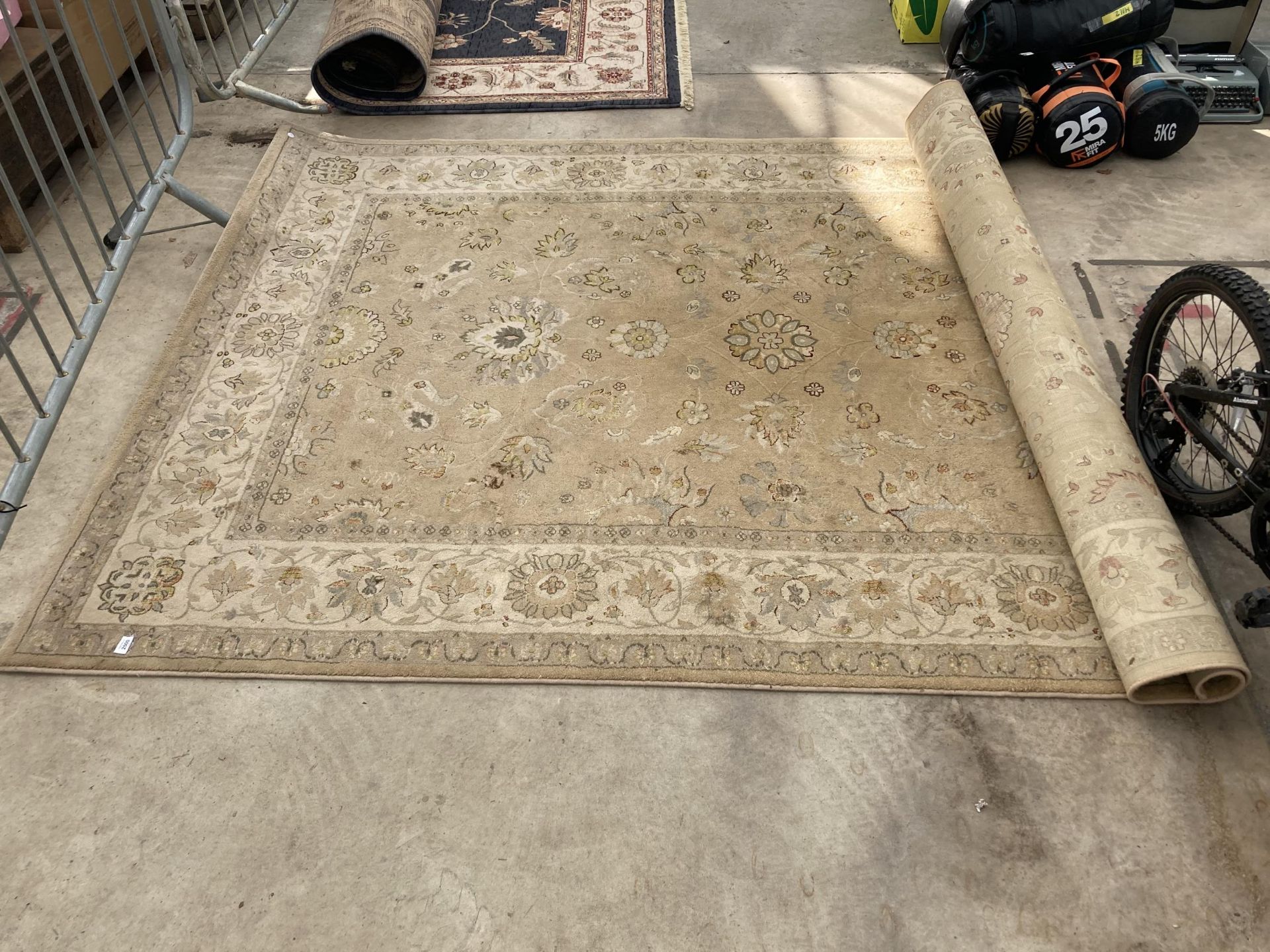 A LARGE CREAM PATTERNED RUG