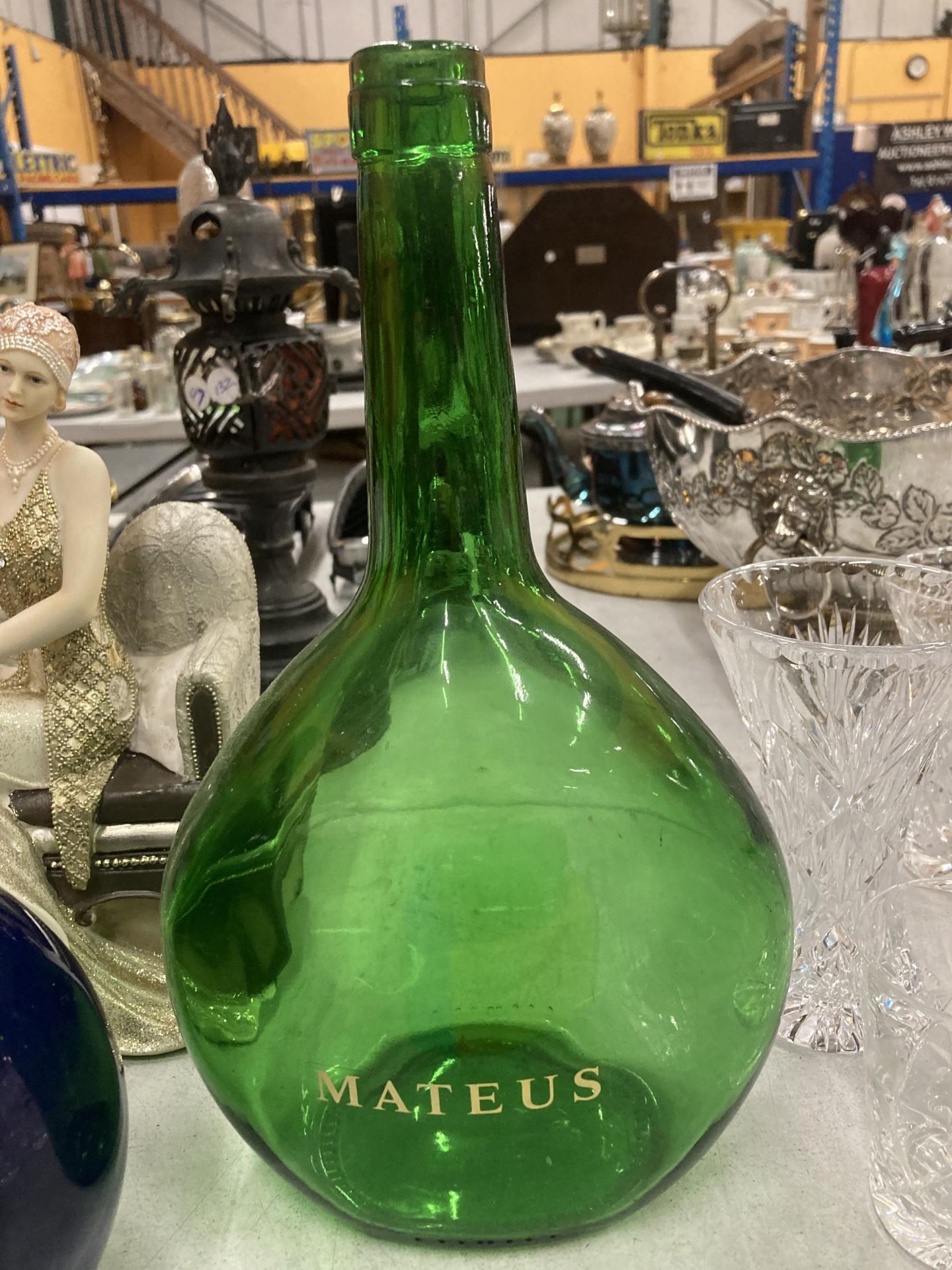 A VINTAGE GREEN GLASS MATEUS WINE DECANTER