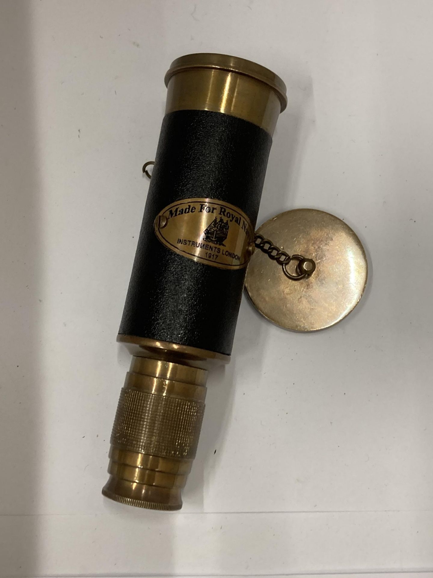 A BRASS AND LEATHER ROYAL NAVY TELESCOPE