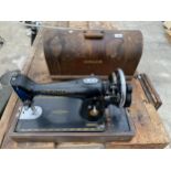 A CASED VINTAGE SINGER SEWING MACHINE