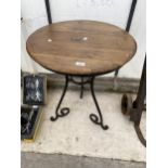 A WOODEN TOPPED BISTRO TABLE WITH HEAVY METAL LEGS