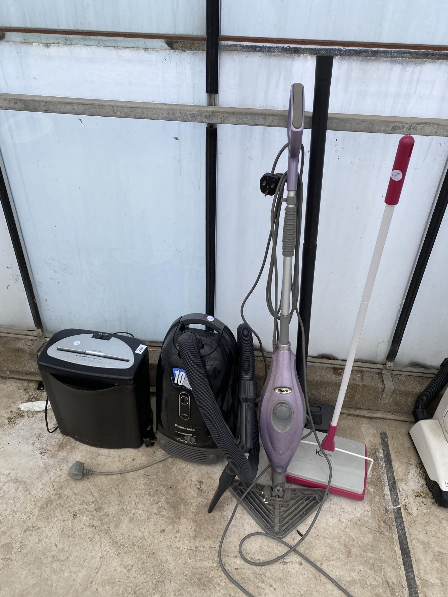 AN ASSORTMENT OF ITEMS TO INCLUDE A PANASONIC VACUUM CLEANER, A SHARK STEAM MOP AND A PAPER SHREDDER