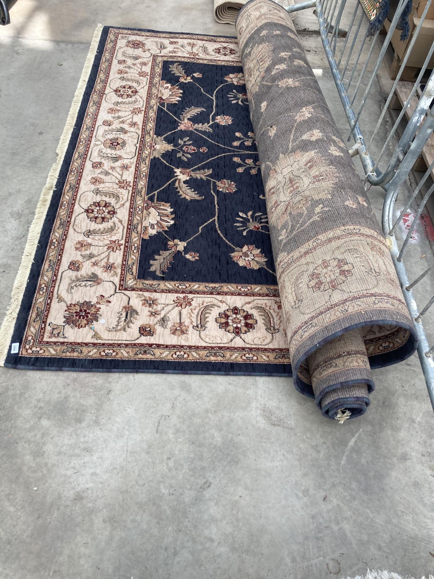 A LARGE BLACK AND CREAM PATTERNED RUG - Image 2 of 2